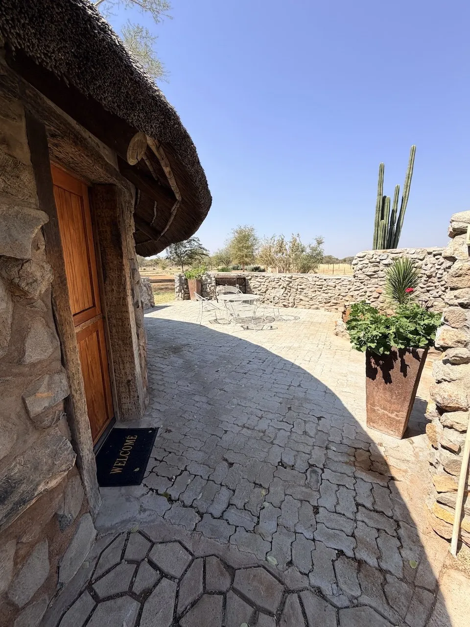 Bungalow entrance and stone-walled courtyard