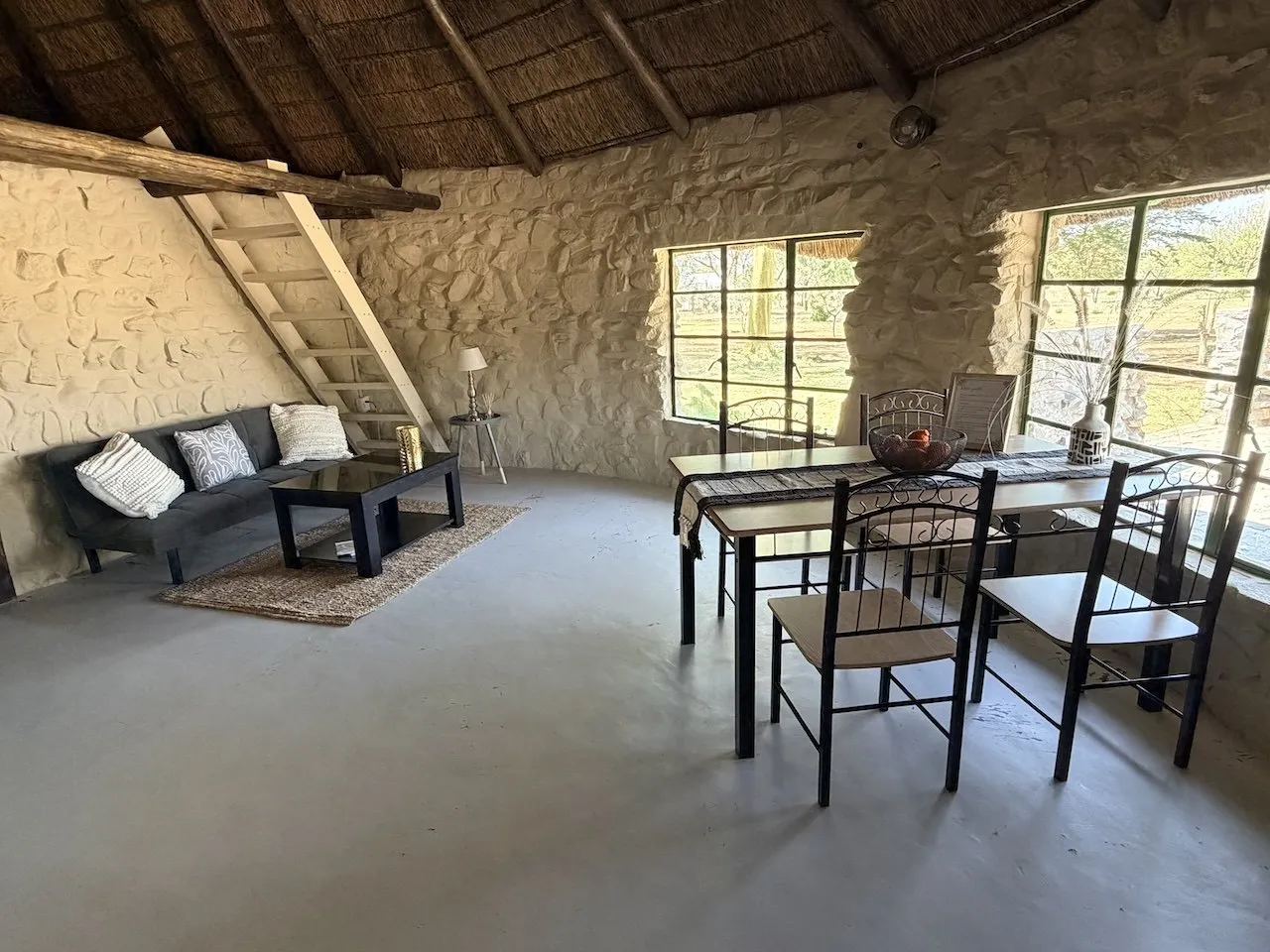 Bungalow lounge and dining area under a wooden ceiling